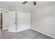 Cozy bedroom with double door closet, ceiling fan, and neutral colored walls at 1050 Chapman Circle Cir, Stone Mountain, GA 30088