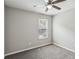 Bedroom featuring neutral colored walls, window with blinds and ceiling fan at 1050 Chapman Circle Cir, Stone Mountain, GA 30088