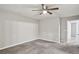 Bedroom with ceiling fan, doorway and plush carpeting at 1050 Chapman Circle Cir, Stone Mountain, GA 30088