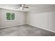 Spacious carpeted bedroom with a ceiling fan, a window view, and neutral paint at 1050 Chapman Circle Cir, Stone Mountain, GA 30088