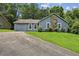 Inviting single-story home with an attached garage, classic siding, and a neatly manicured lawn at 1050 Chapman Circle Cir, Stone Mountain, GA 30088