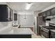 Stylish kitchen with granite counters, stainless appliances, dark cabinetry, and a breakfast bar at 1050 Chapman Circle Cir, Stone Mountain, GA 30088