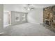 Open living room featuring plush carpeting, a cozy fireplace, and ample natural light from large windows at 1050 Chapman Circle Cir, Stone Mountain, GA 30088