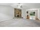Cozy living room showcasing a brick fireplace and opening to a dining area with hardwood flooring at 1050 Chapman Circle Cir, Stone Mountain, GA 30088