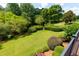 Beautiful backyard featuring a well maintained lawn, mature landscaping, and manicured shrubs at 130 Hamilton Way, Roswell, GA 30075