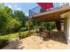 Outdoor patio featuring a dining set, grill, and lush landscape view at 130 Hamilton Way, Roswell, GA 30075