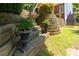 Multi-tiered backyard landscaping, including planters and greenery at 130 Hamilton Way, Roswell, GA 30075