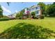 Sprawling backyard with lush lawn, deck with red umbrella and mature landscaping at 130 Hamilton Way, Roswell, GA 30075