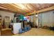 Unfinished basement with exposed ceiling, laundry appliances, and storage solutions at 130 Hamilton Way, Roswell, GA 30075