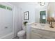 A well-lit bathroom with a shower/tub combo and vanity with white cabinets at 130 Hamilton Way, Roswell, GA 30075