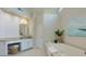 This bathroom features a soaking tub and a vanity with granite countertop at 130 Hamilton Way, Roswell, GA 30075