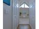 Hallway view into a pristine bathroom featuring a soaking tub and a triangular window at 130 Hamilton Way, Roswell, GA 30075
