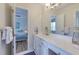 Bright bathroom features a long vanity with white cabinets and ensuite bedroom at 130 Hamilton Way, Roswell, GA 30075