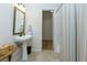 Bathroom with pedestal sink, neutral paint, and a doorway to another room at 130 Hamilton Way, Roswell, GA 30075