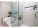 Bright bathroom features a soaking tub and seamless glass shower with built-in niche at 130 Hamilton Way, Roswell, GA 30075