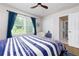 Bright bedroom features hardwood floors, a ceiling fan, and natural light at 130 Hamilton Way, Roswell, GA 30075