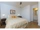 This cozy bedroom features hardwood floors, a ceiling fan, and ensuite bathroom at 130 Hamilton Way, Roswell, GA 30075