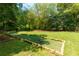 Bocce court in expansive back yard featuring mature trees and plantings at 130 Hamilton Way, Roswell, GA 30075