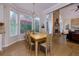 Light filled dining room leads to an open living space with a stone fireplace and soaring ceilings at 130 Hamilton Way, Roswell, GA 30075