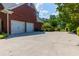 Long driveway leading to a two-car garage on a large lot at 130 Hamilton Way, Roswell, GA 30075