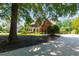 Traditional brick home with a bay window and a curved driveway at 130 Hamilton Way, Roswell, GA 30075