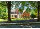 Beautiful two-story brick home with manicured front lawn at 130 Hamilton Way, Roswell, GA 30075