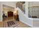 Inviting foyer with hardwood floors, elegant staircase, and a view into the adjacent living space at 130 Hamilton Way, Roswell, GA 30075