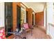 Cozy front porch with seating area and classic brick accents at 130 Hamilton Way, Roswell, GA 30075