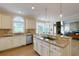 Modern kitchen featuring granite countertops, stainless steel appliances, and a center island cooktop at 130 Hamilton Way, Roswell, GA 30075