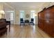 Inviting living room with hardwood floors, piano, and natural light streaming through the windows at 130 Hamilton Way, Roswell, GA 30075