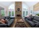 A spacious living room with a stone fireplace, hardwood floors and plenty of room to entertain at 130 Hamilton Way, Roswell, GA 30075