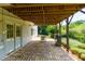 Stone patio with an outdoor grill, dining table, and view of the well-manicured backyard at 130 Hamilton Way, Roswell, GA 30075