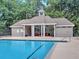 Pool house with seating area featuring ceiling fans and comfortable furniture next to a community pool at 130 Hamilton Way, Roswell, GA 30075