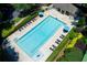 Aerial view of community pool with lounge chairs, umbrellas, and manicured landscaping around the pool deck at 130 Hamilton Way, Roswell, GA 30075