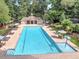 Community pool with splash fountain area, pool house, poolside seating, and manicured landscaping at 130 Hamilton Way, Roswell, GA 30075