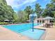 Resort style pool featuring a fountain feature, poolside seating, and a covered cabana for relaxing at 130 Hamilton Way, Roswell, GA 30075
