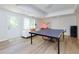 Finished recreation room with ping pong table, recessed lights, and access to the outside via a door at 130 Hamilton Way, Roswell, GA 30075
