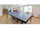 Spacious recreation room with ping pong table and laminate flooring; perfect for entertaining at 130 Hamilton Way, Roswell, GA 30075
