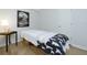 Bright room featuring a massage table, modern art, and light-colored wood floors at 130 Hamilton Way, Roswell, GA 30075