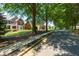 Street view showcases a beautiful home with mature trees and well-kept landscaping at 130 Hamilton Way, Roswell, GA 30075