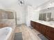 Spacious bathroom featuring double vanity, soaking tub, and separate shower at 1525 Lake Dow Rd, Mcdonough, GA 30252
