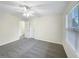 This bedroom features neutral walls, carpet flooring, and a ceiling fan, creating a clean and inviting space at 1525 Lake Dow Rd, Mcdonough, GA 30252