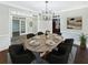 Elegant dining room with modern chandelier, wood floors, and seating for six at 1525 Lake Dow Rd, Mcdonough, GA 30252