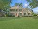 Charming two-story traditional home with a well-manicured lawn and lush greenery at 1525 Lake Dow Rd, Mcdonough, GA 30252