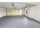 Spacious two car garage featuring a painted floor and natural light at 1525 Lake Dow Rd, Mcdonough, GA 30252