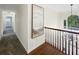 Bright hallway featuring hardwood floors, a painting, and views of the outdoors through a window at 1525 Lake Dow Rd, Mcdonough, GA 30252