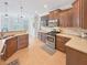 Well-lit kitchen showcasing stainless steel appliances, countertops, and a breakfast bar at 1525 Lake Dow Rd, Mcdonough, GA 30252