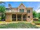 Spacious backyard features a screened-in porch, stone grill, lush lawn, and brick exterior at 2317 Whiting Bay Courts Nw, Kennesaw, GA 30152