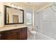 Bright bathroom featuring a shower-tub combo, and a framed mirror above a single sink at 2317 Whiting Bay Courts Nw, Kennesaw, GA 30152