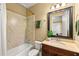 Well-lit bathroom with tiled shower and tub, vanity, and neutral walls at 2317 Whiting Bay Courts Nw, Kennesaw, GA 30152